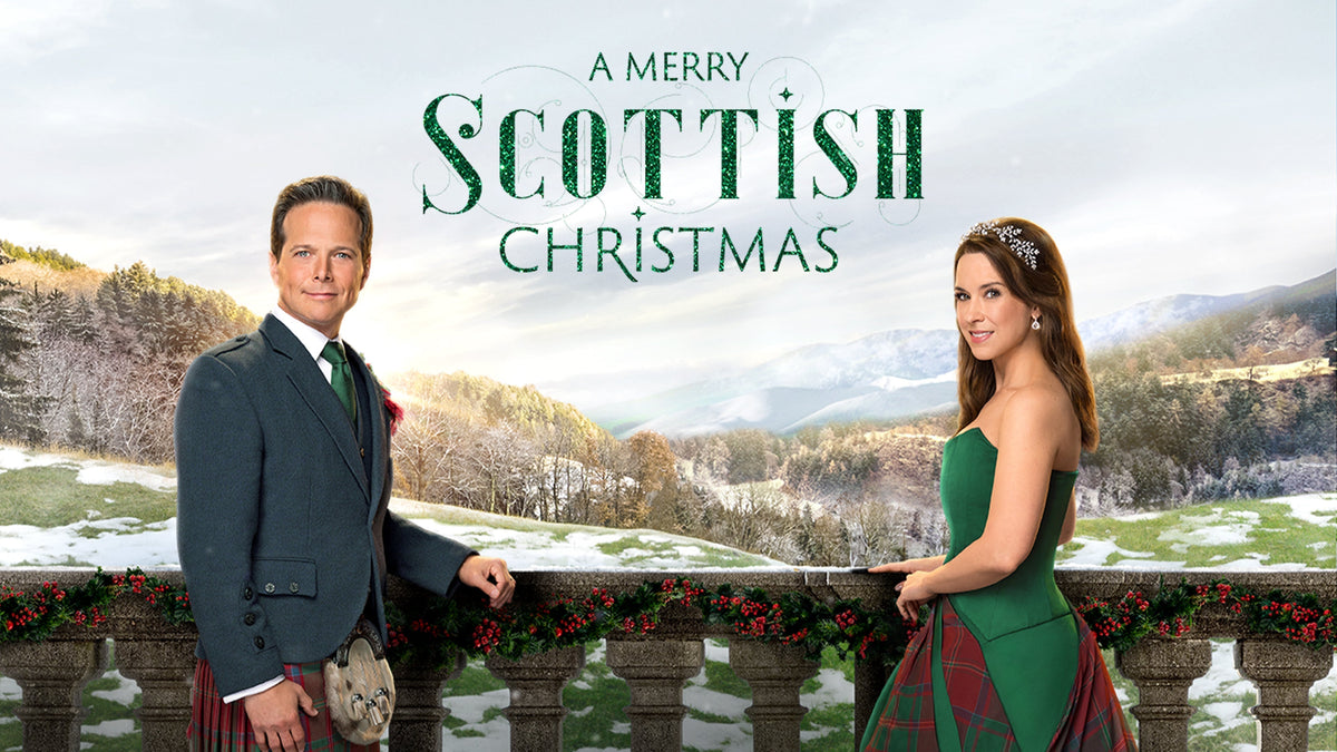 Promotional poster showing Scott Wolf in a kilt suit and Lacey Chabert in a green tartan gown leaning on a snow-dusted stone balustrade decorated with evergreen garland against a snowy Scottish mountain backdrop.