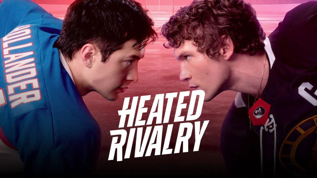Official title banner for Heated Rivalry showing Hudson Williams and Connor Storrie in their hockey jerseys facing off intensely on the ice.