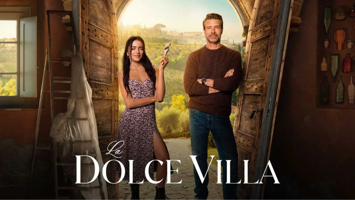 Official title poster for Netflix movie La Dolce Villa starring Maia Reficco holding a paintbrush alongside Scott Foley in a rustic wooden doorway.