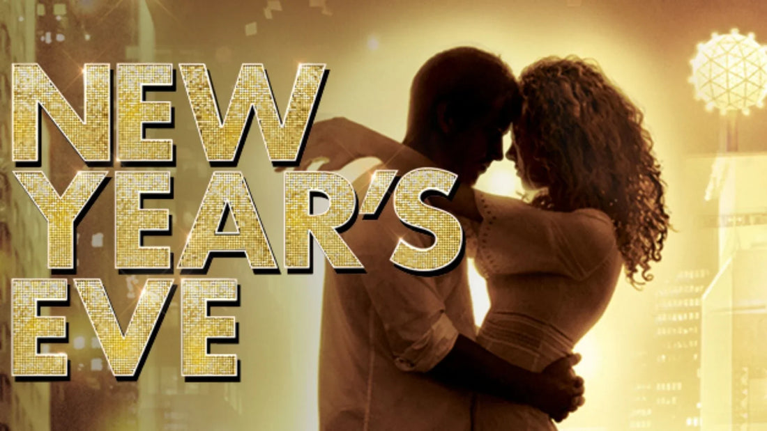 Title poster for the movie New Year's Eve with large gold glittery text featuring a silhouetted man and woman embracing in a romantic pose against a bright Times Square backdrop with the glowing New Year's ball.