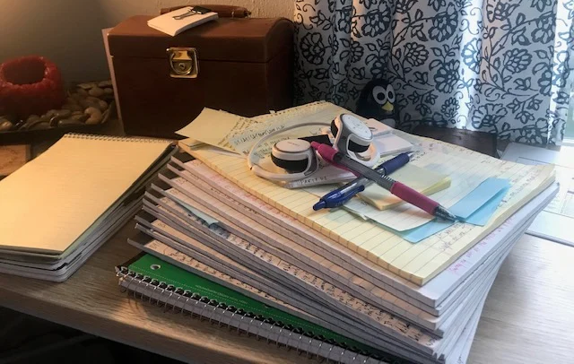 An image of notebooks, pens and ideas